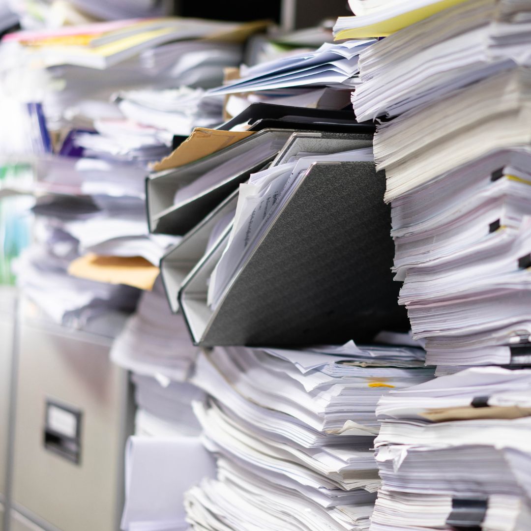 image of a file cabinet with lots of papers on top a reason to go digital with work orders