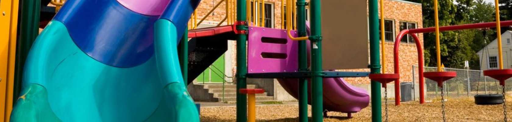 Image of a playground with loose fill wood chip surfacing