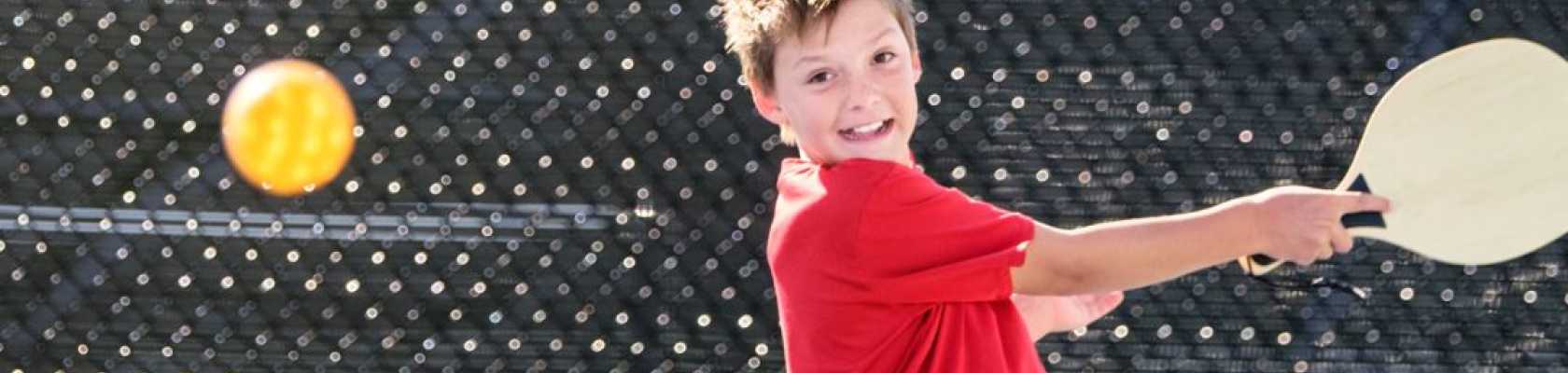 image of teenager playing on a maintained pickleball court