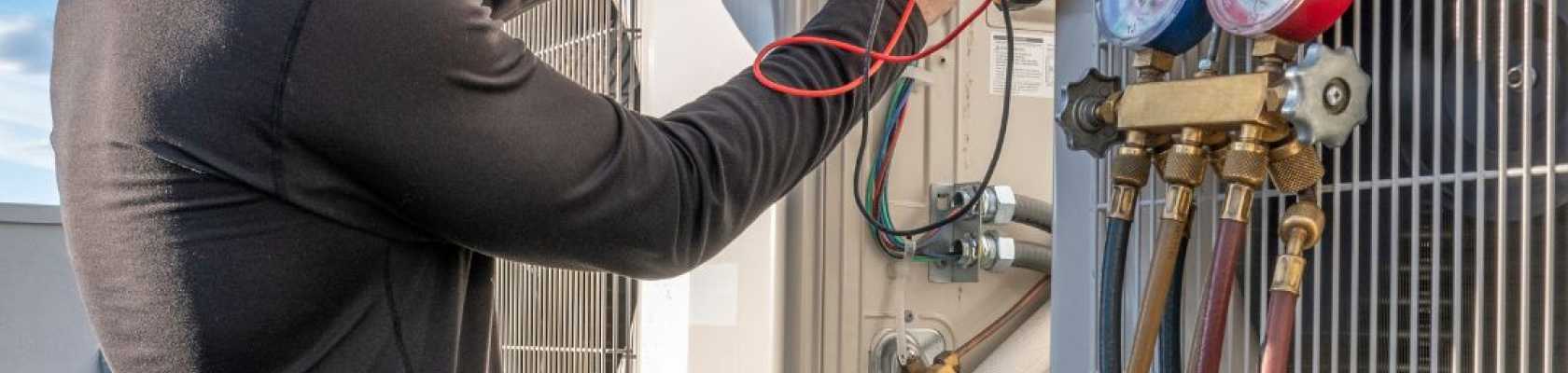 Image of man doing maintenance on an HVAC system for a recreation facility