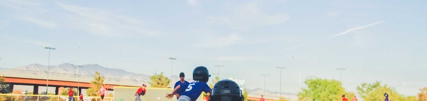 Image of kids playing on maintained baseball field