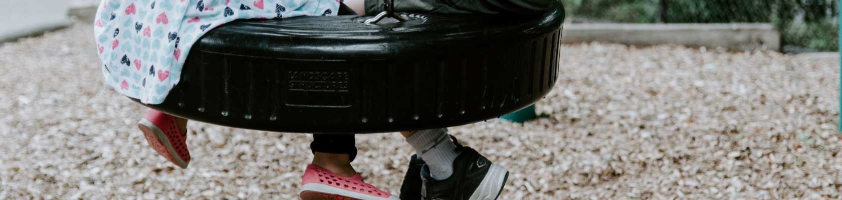 Children swinging on a safe, maintained playground