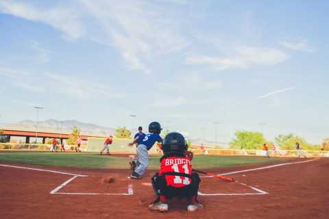 Image of kids playing on maintained baseball field