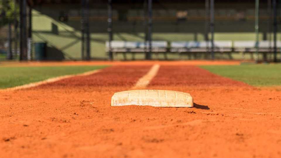 image of a ballfield that has been maintained near the first base line