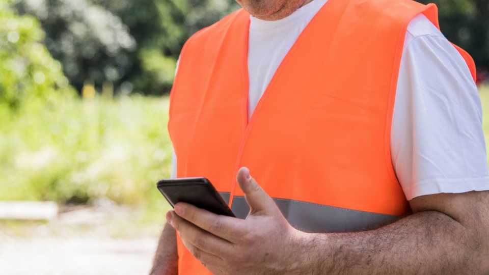 Image of park worker using maintenance management software