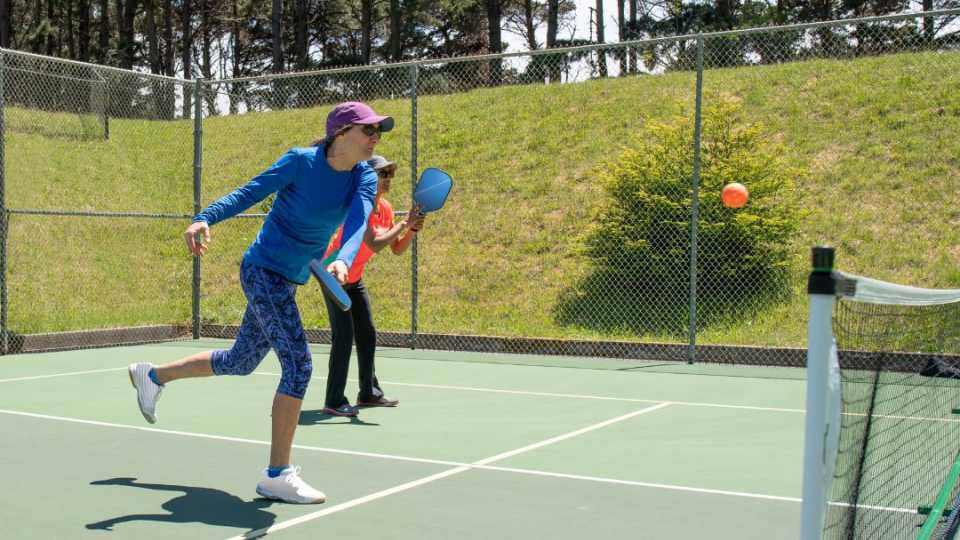 Image if people playing on a pickleball court installation