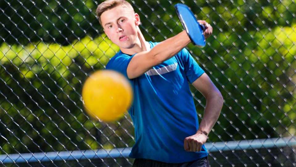 Images of someone playing on a pickleball court