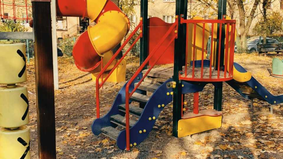 Image of playground in the fall that needs maintenance