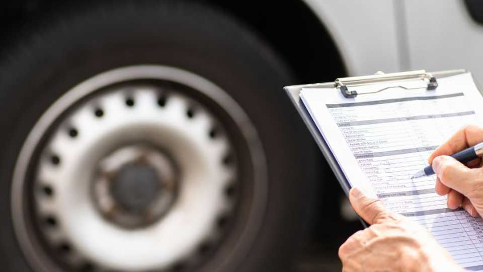 Image of a parks worker performing preventative maintenance on a vehicle