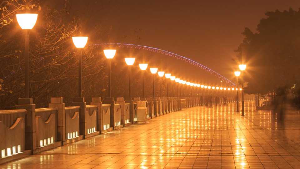 Title image of light pollution. Streetlights giving off excess lights on a city street.